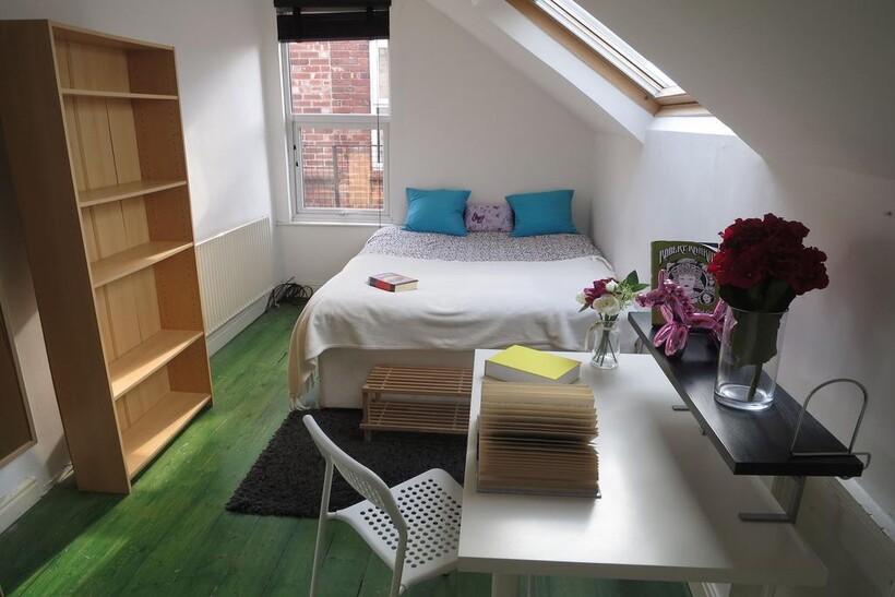 Bright and cozy single bedroom featuring a bed ...