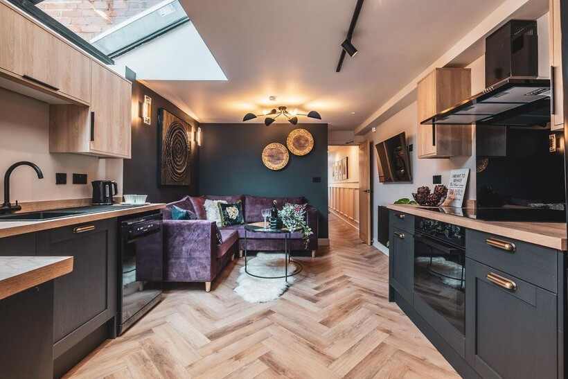 Stylish open-plan living area with a modern kit...