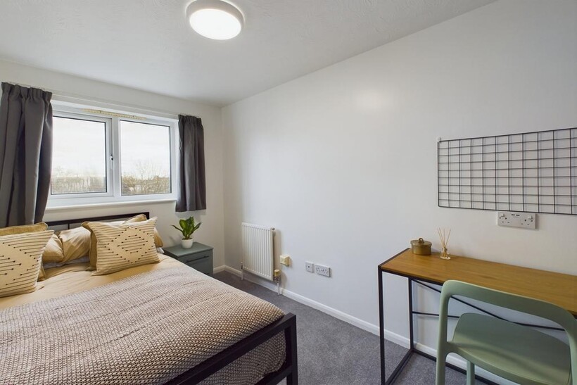 A bright and inviting double bedroom featuring ...