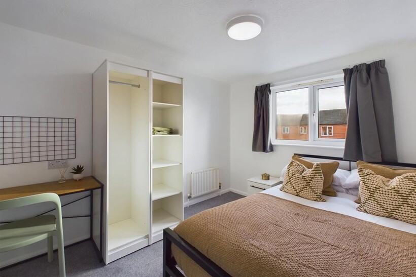 A bright and inviting double bedroom with ample...