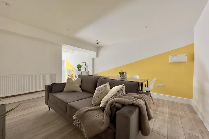 A bright and inviting large modern living room,...