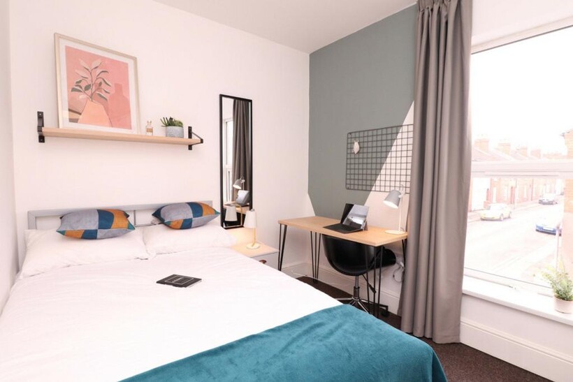 A bright and stylish double bedroom featuring m...