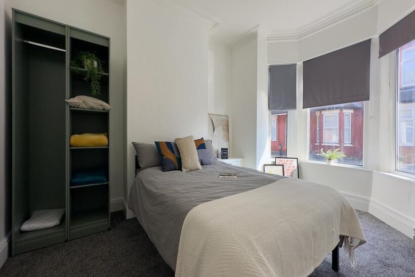 A bright and spacious double bedroom with moder...