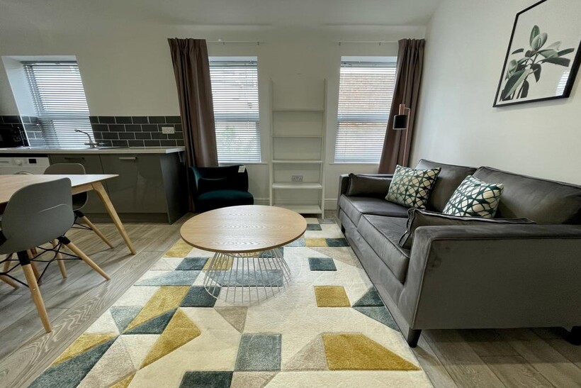 A bright and inviting living room featuring a c...