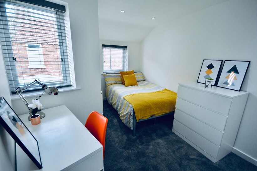 Bright and inviting bedroom with a cozy bed dre...