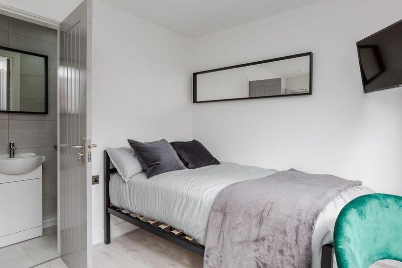 A modern, well-kept double bedroom featuring a ...