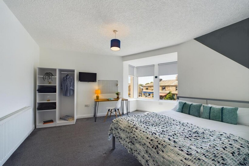 A bright and tidy living room featuring a large...