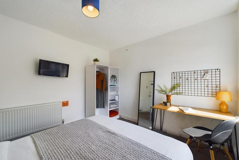 Bright and spacious master bedroom featuring a ...