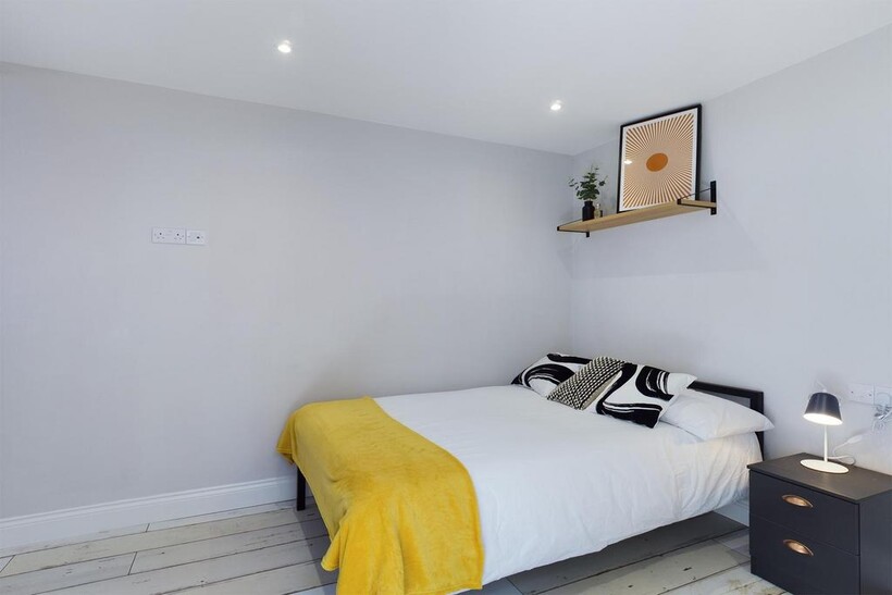 A bright and stylish double bedroom featuring m...