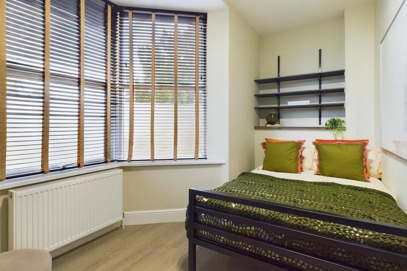 A bright and inviting double bedroom featuring ...