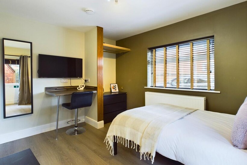 A stylish and well-lit double bedroom featuring...