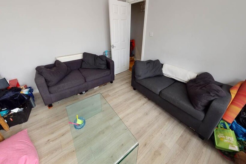 Spacious and well-lit living room featuring two...