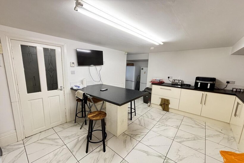 A bright, spacious living room featuring a larg...