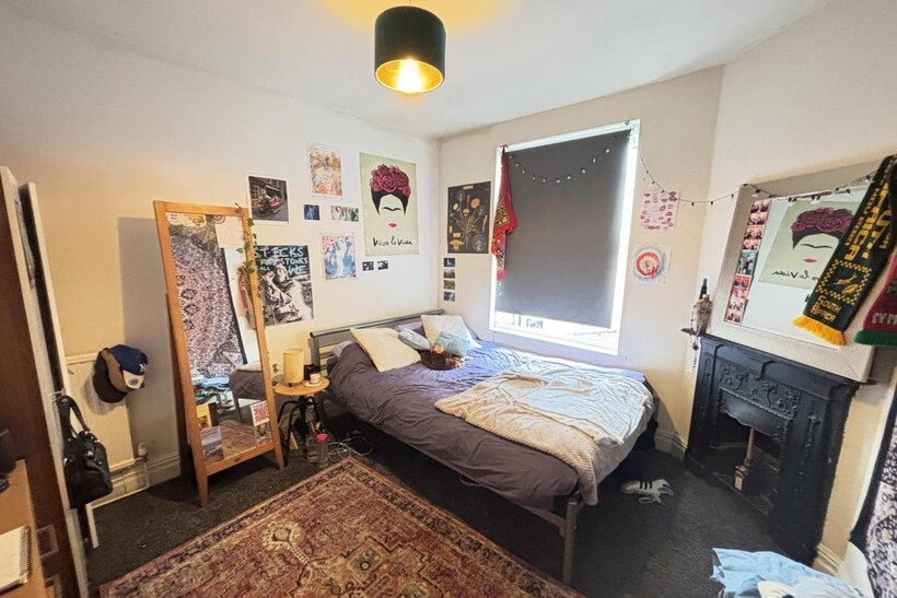 A spacious and cozy master bedroom featuring a ...