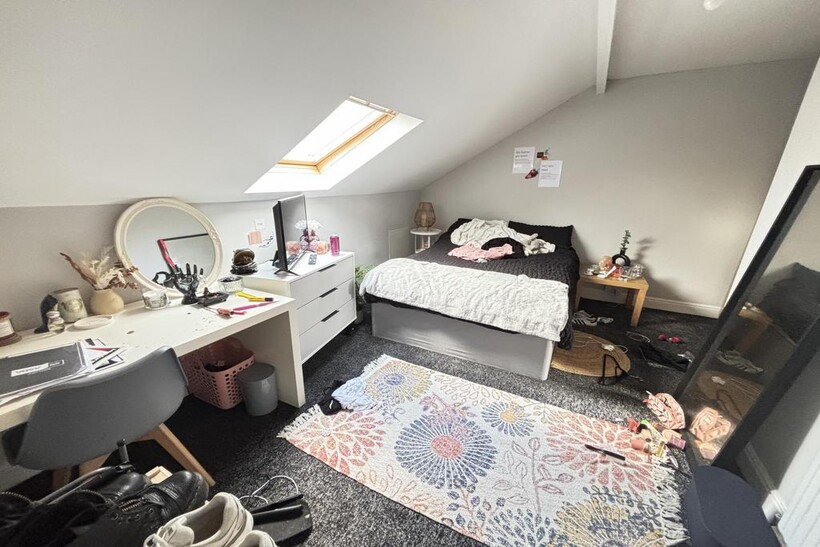 A bright and well-maintained bedroom featuring ...