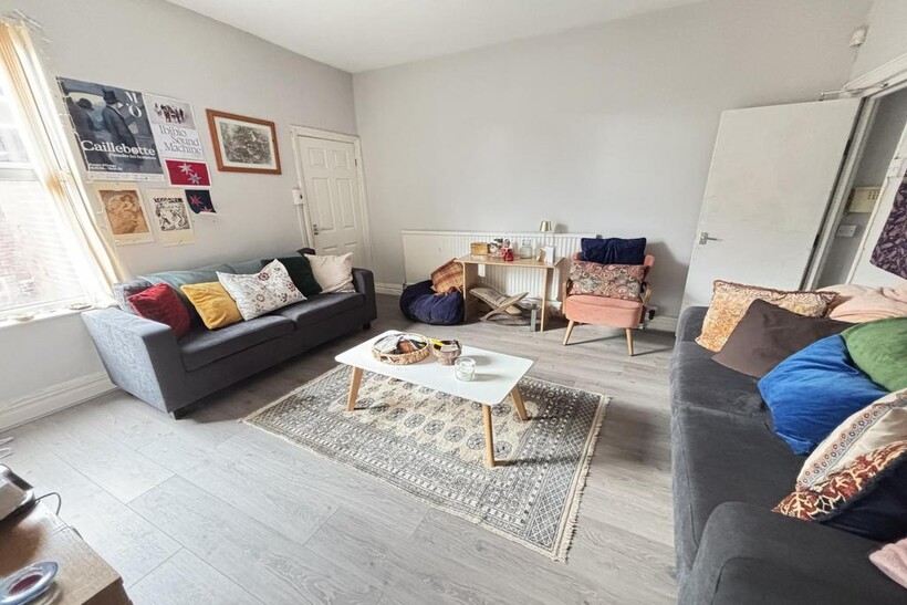 A bright and welcoming living room featuring co...