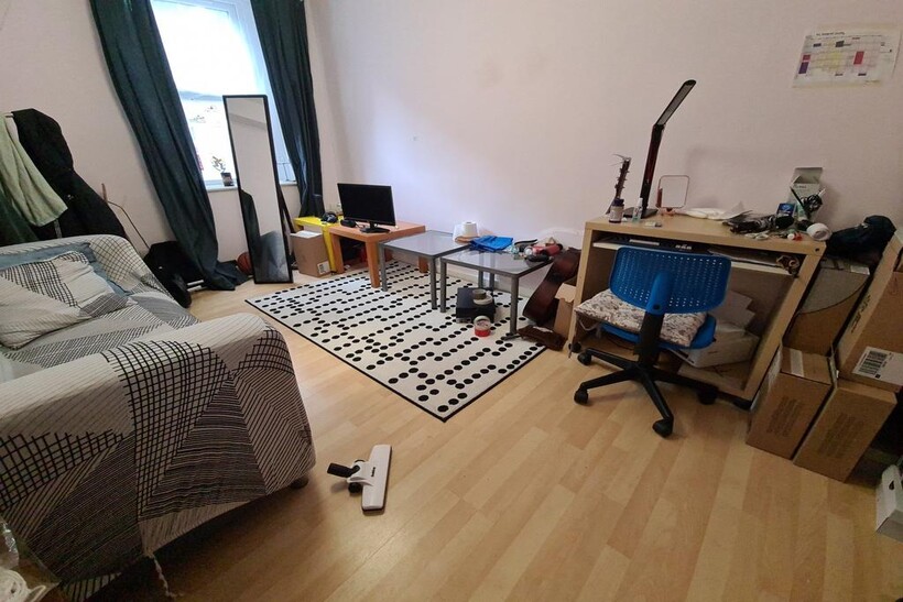 Bright, tidy bedroom with wood-effect flooring,...