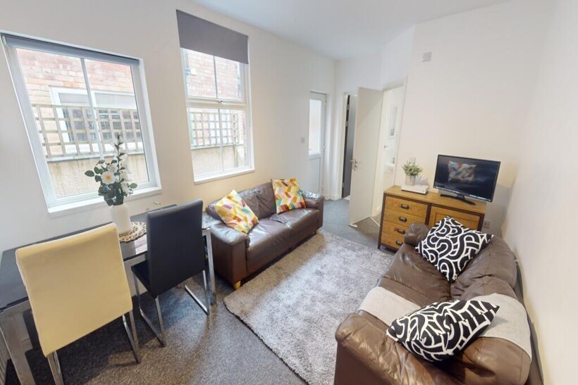 Bright and welcoming living room featuring larg...