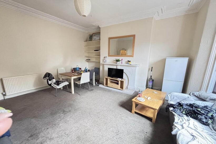 A spacious and well-lit contemporary living roo...