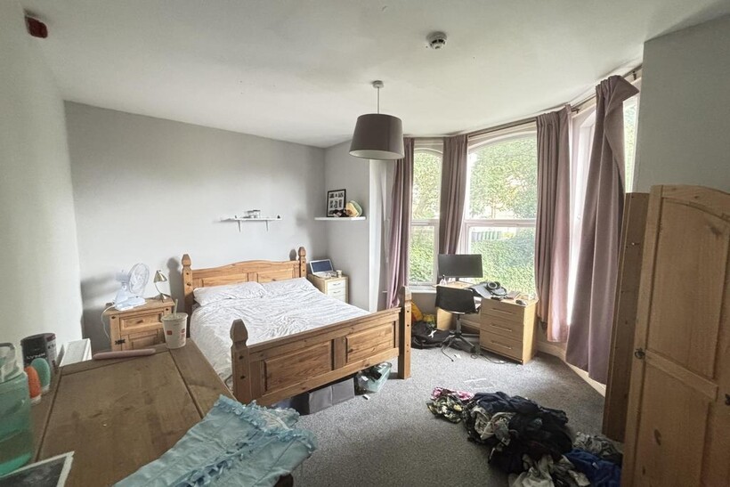 A bright and inviting master bedroom featuring ...