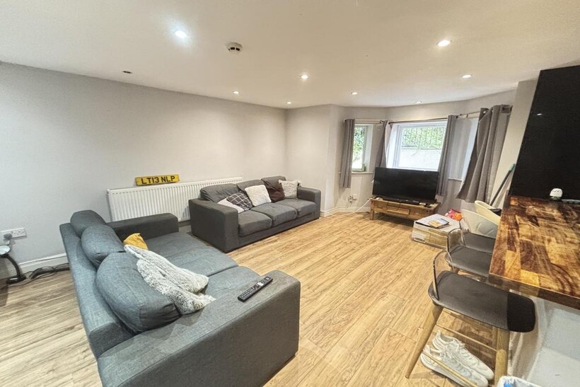 A spacious and well-lit contemporary living roo...