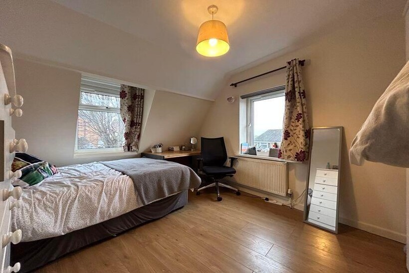 A bright and inviting bedroom featuring a singl...