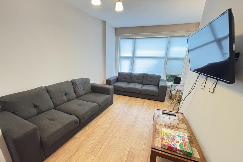 A modern, well-lit living room with two large, ...