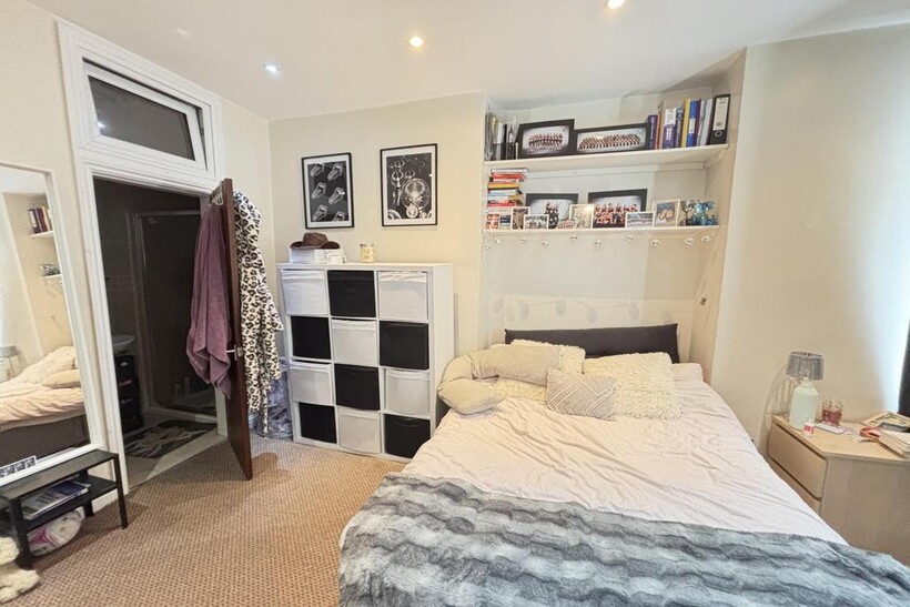 A bright and cozy bedroom featuring a comfortab...