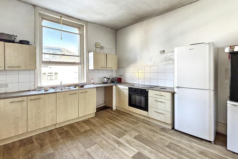 A bright and clean kitchen with ample natural l...