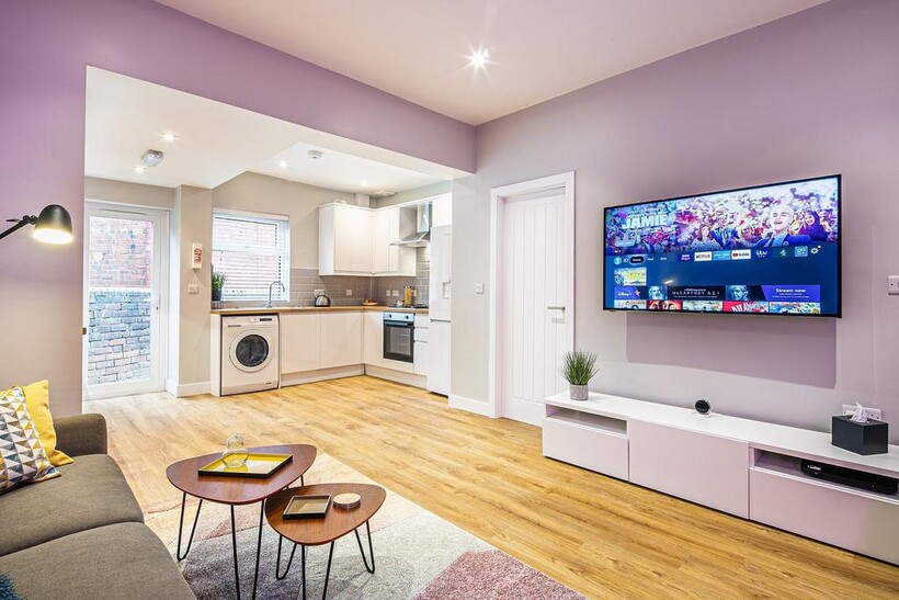 Bright and modern living room featuring a large...