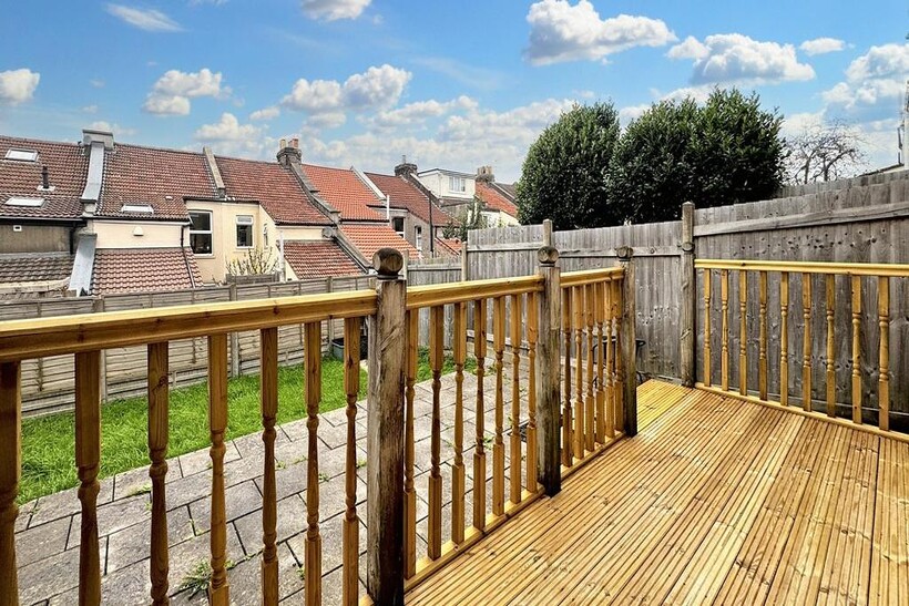 Sunny raised wooden decking with sturdy railing...