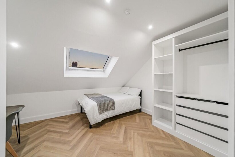 A tidy, well-lit single bedroom featuring a com...
