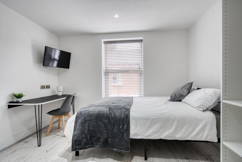 A bright and spacious master bedroom featuring ...