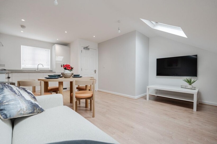 Bright and modern living room with ample natura...