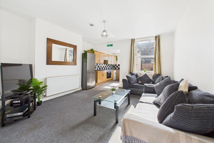 A bright and spacious living room with a large ...