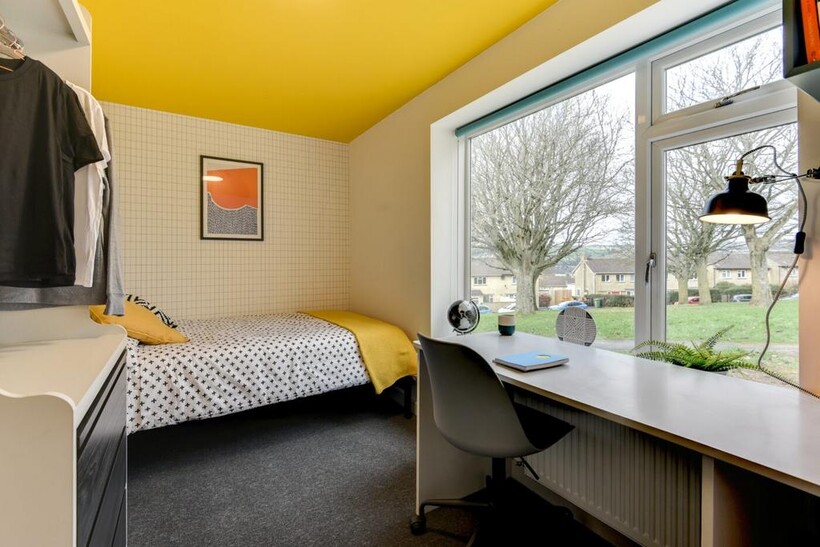 Bright, modern bedroom with a cosy single bed d...