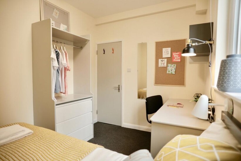 Bright and inviting student bedroom featuring a...