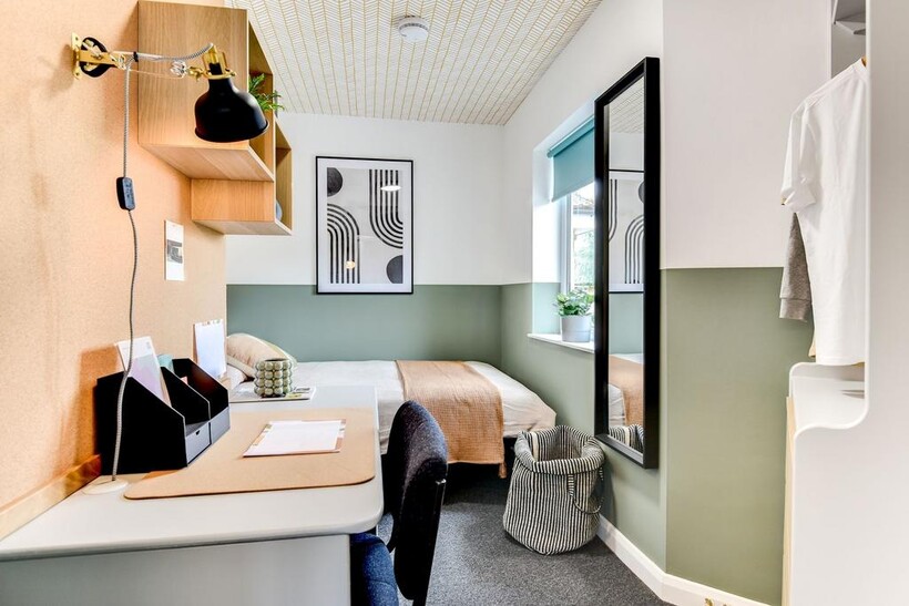 This stylish double bedroom features a cozy bed...