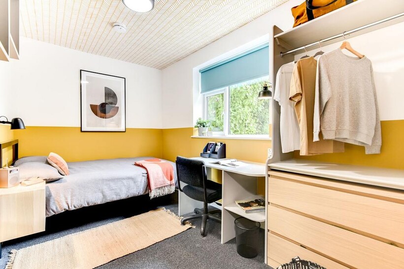 Charming double bedroom featuring a cozy bed, a...