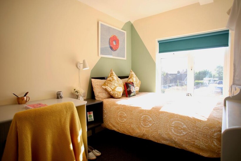 Bright and cozy double bedroom featuring a styl...