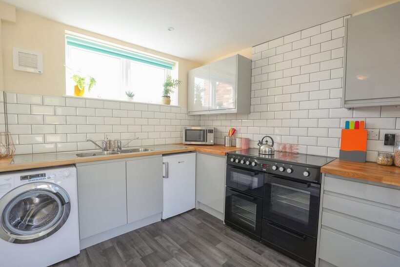 Bright and modern kitchen featuring sleek cabin...