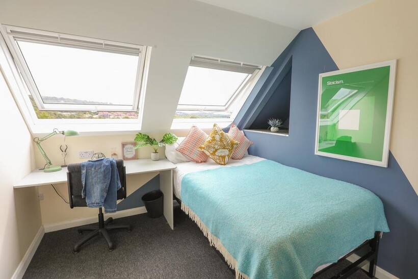 Bright and cozy double bedroom featuring two la...