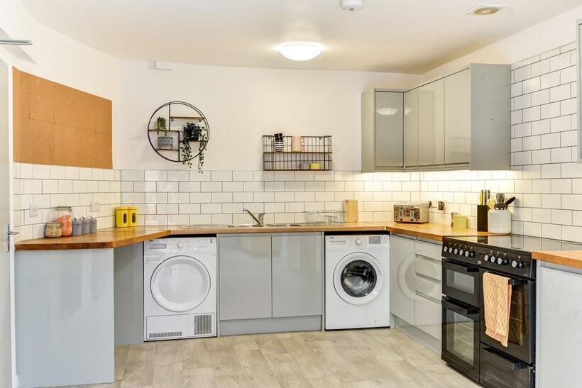 Bright and modern kitchen featuring sleek grey ...