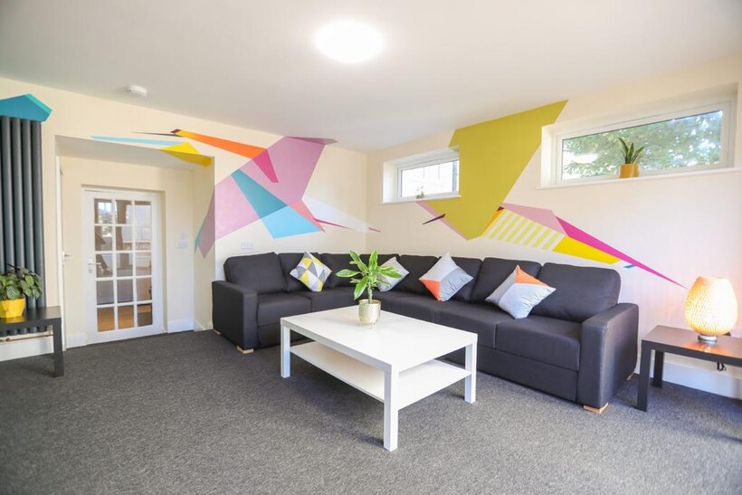 Bright and contemporary living room featuring a...