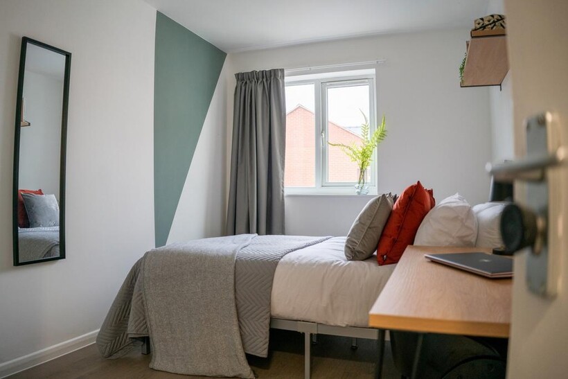 A bright and inviting double bedroom with moder...