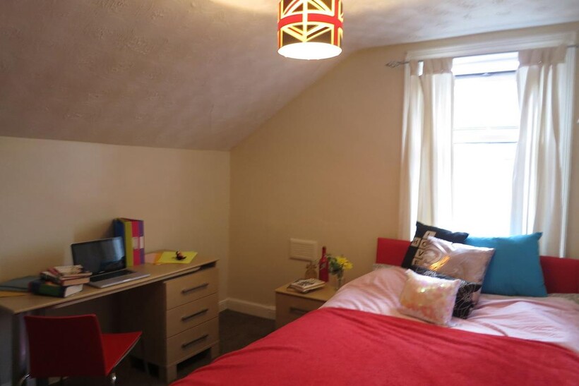 Bright, cosy bedroom with a comfortable bed dre...