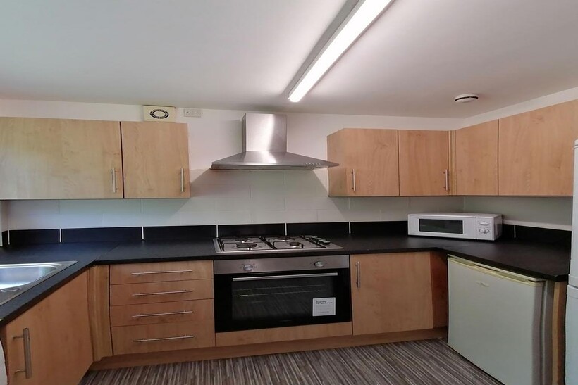 Modern fitted kitchen with wood-effect cabinets...