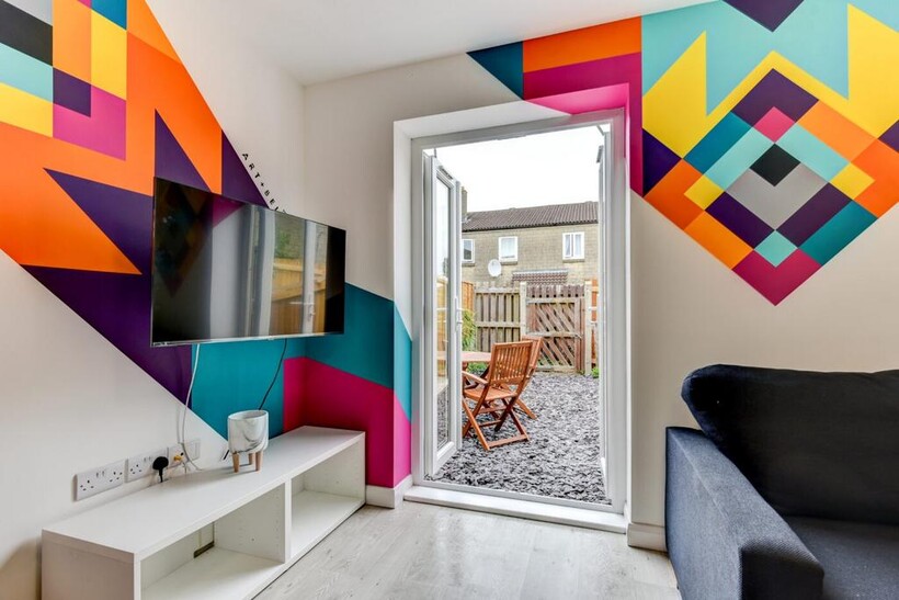 Bright contemporary living area with bold geome...