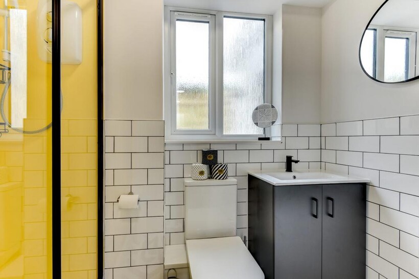 Bright modern bathroom with a walk-in shower fe...