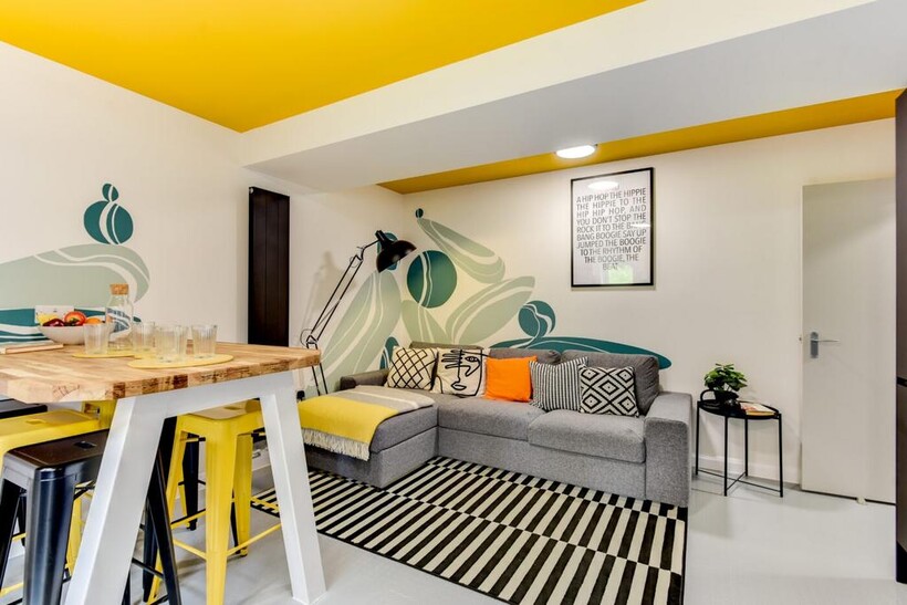 Bright, modern living area with a comfortable g...